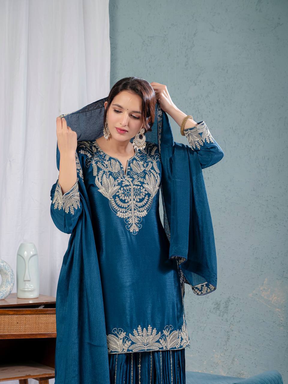 Luxurious outfit with golden accents and floral embroidery